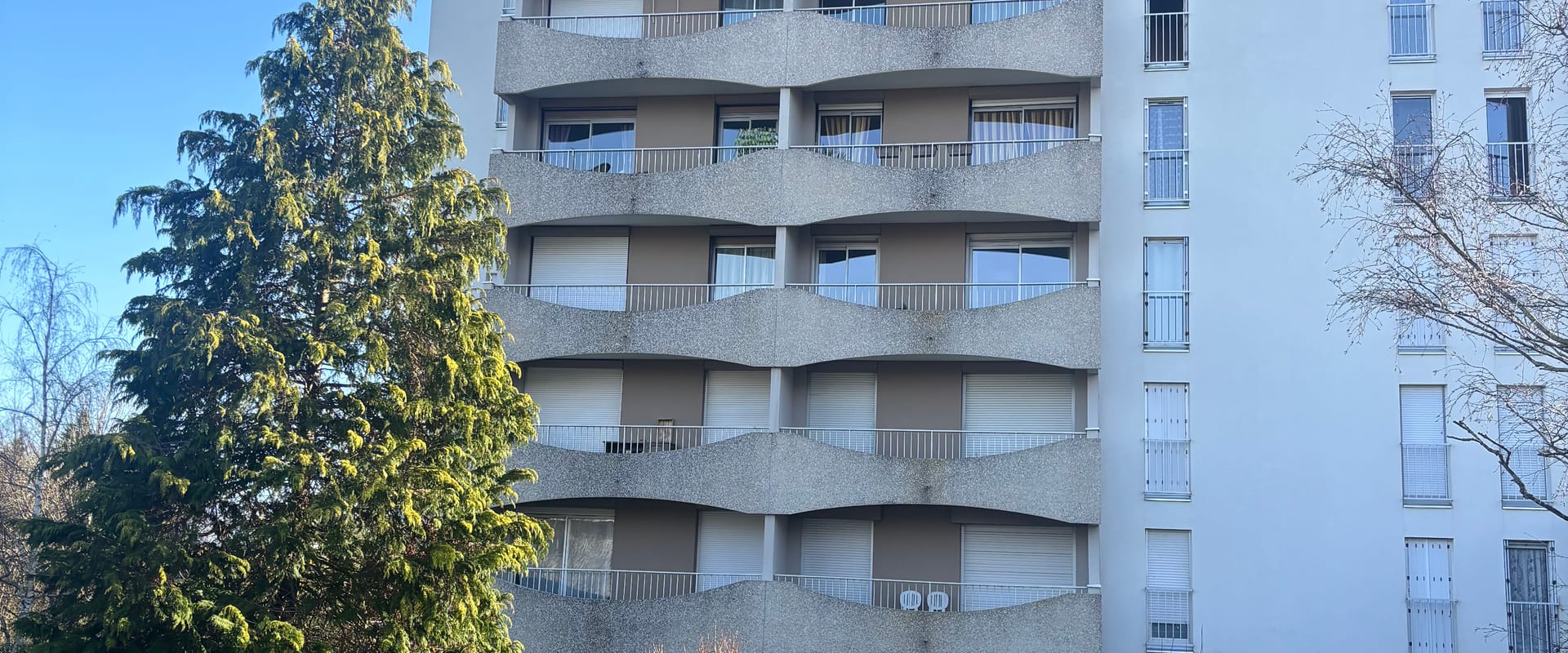 Façade d'immeuble résidentiel avec jardins